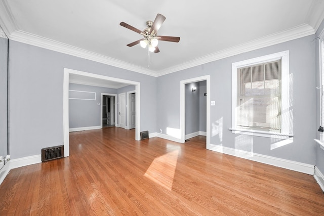 spare room with crown molding, ceiling fan, and light wood-type flooring