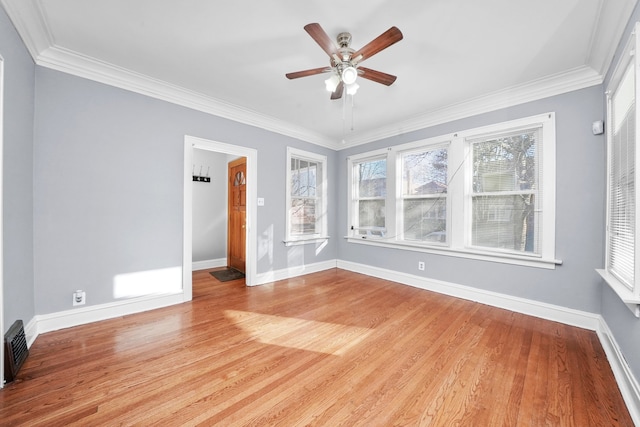 spare room featuring crown molding, ceiling fan, and light hardwood / wood-style flooring