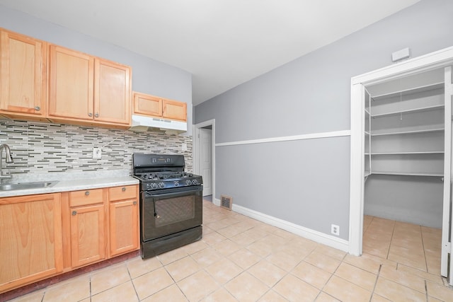 kitchen with sink, light tile patterned floors, black range with gas stovetop, and backsplash