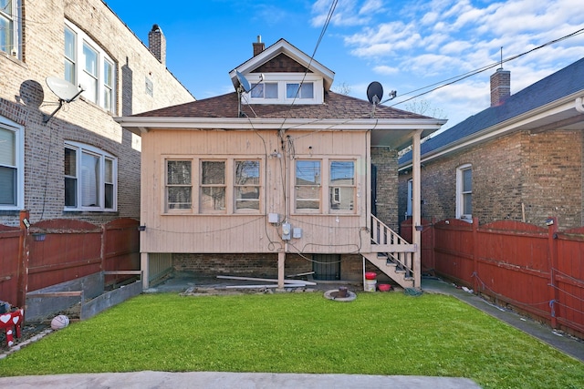 back of house featuring a yard