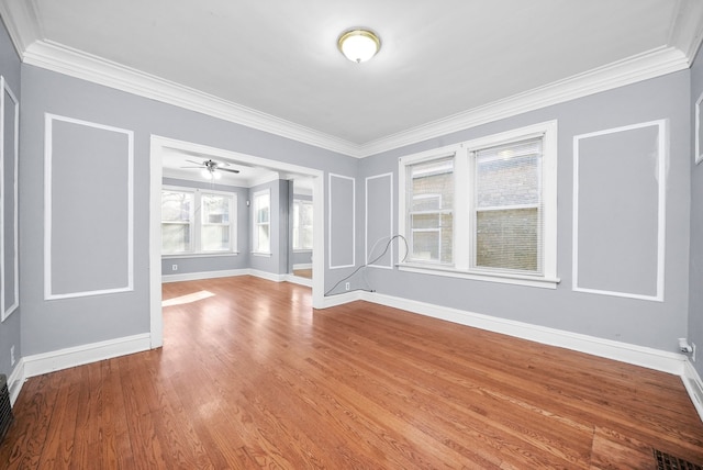 empty room featuring ceiling fan, ornamental molding, and light hardwood / wood-style flooring