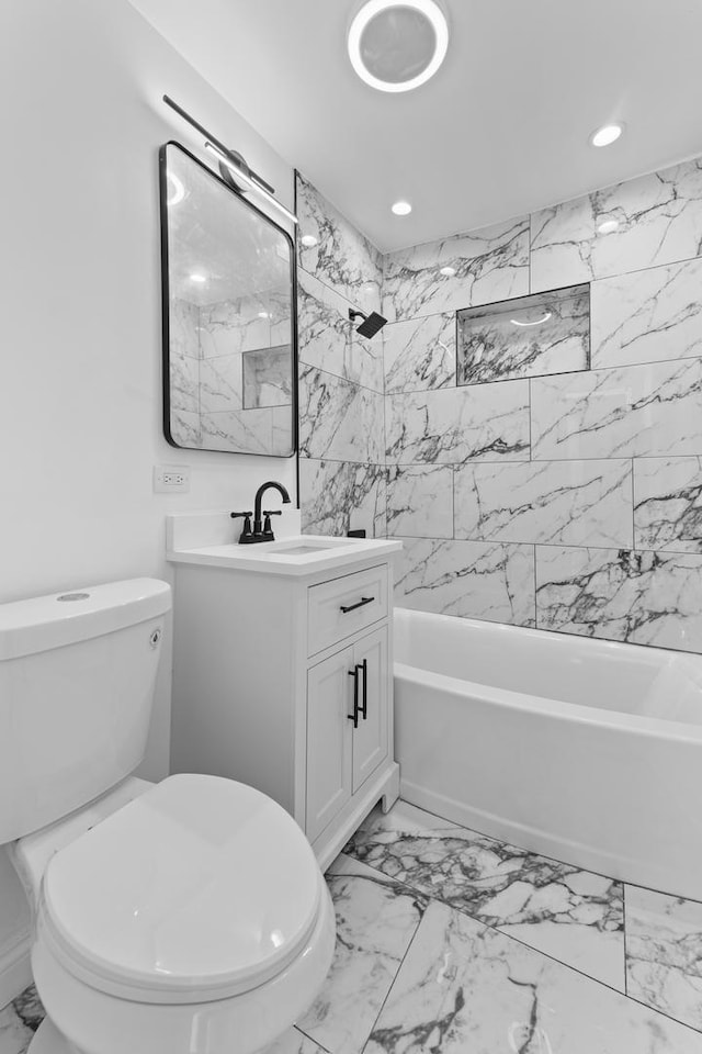 full bathroom with vanity, toilet, and tiled shower / bath