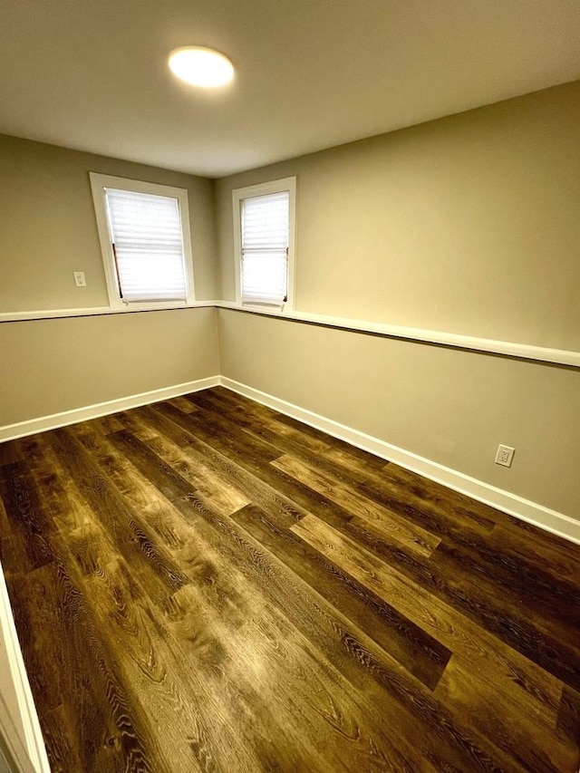 unfurnished room featuring dark wood-type flooring