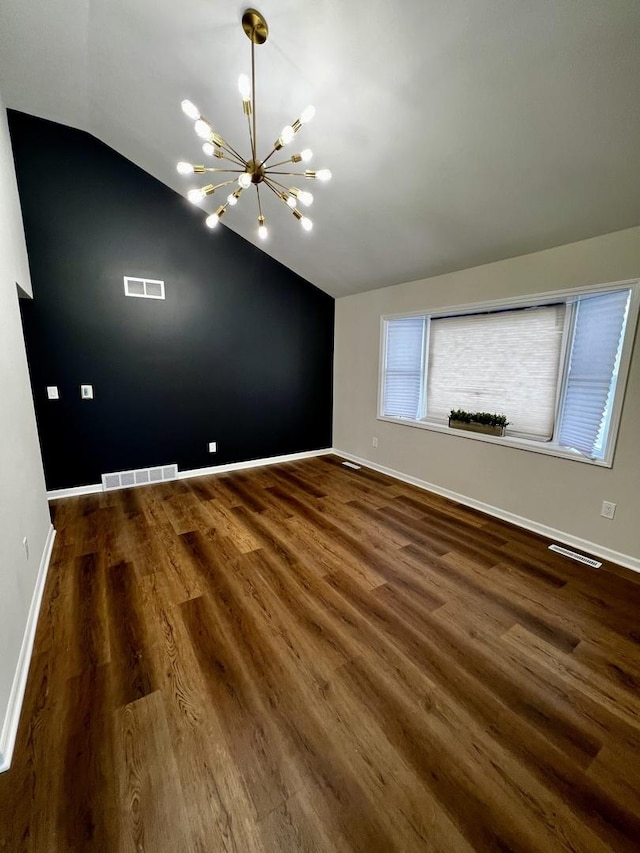 interior space featuring dark hardwood / wood-style flooring, lofted ceiling, and an inviting chandelier