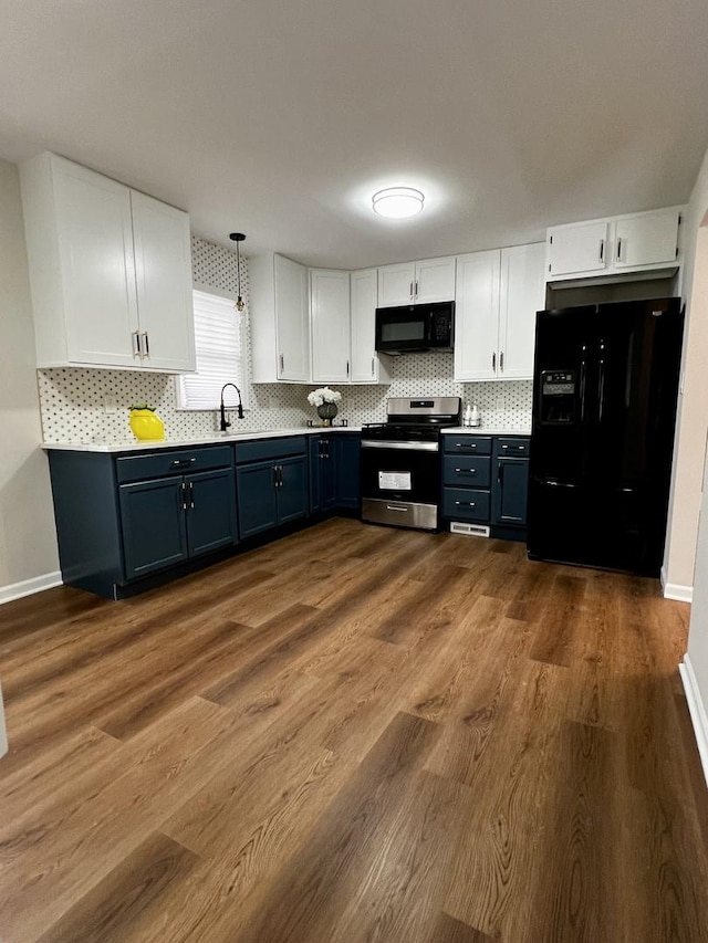 kitchen with black appliances, white cabinets, pendant lighting, and dark wood-type flooring