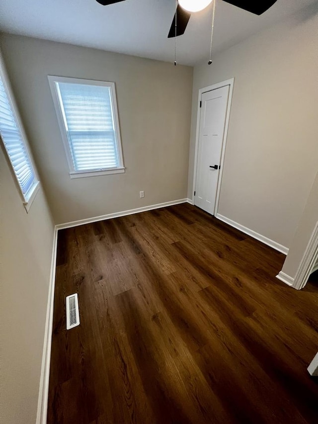 spare room featuring ceiling fan and dark hardwood / wood-style flooring