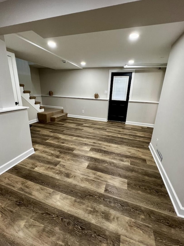 basement featuring dark hardwood / wood-style flooring