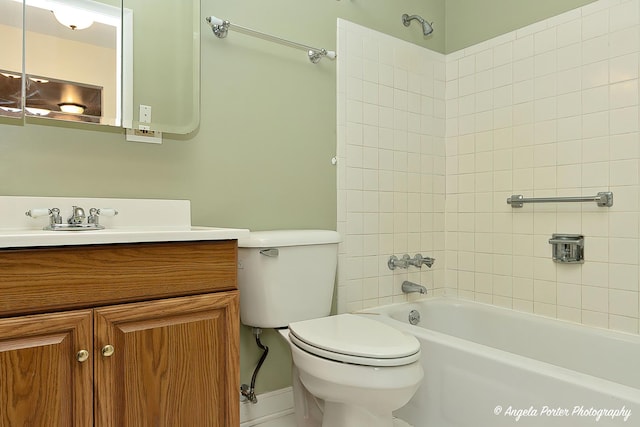 full bathroom with vanity, toilet, and tiled shower / bath