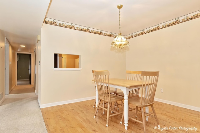 dining space featuring light wood-type flooring