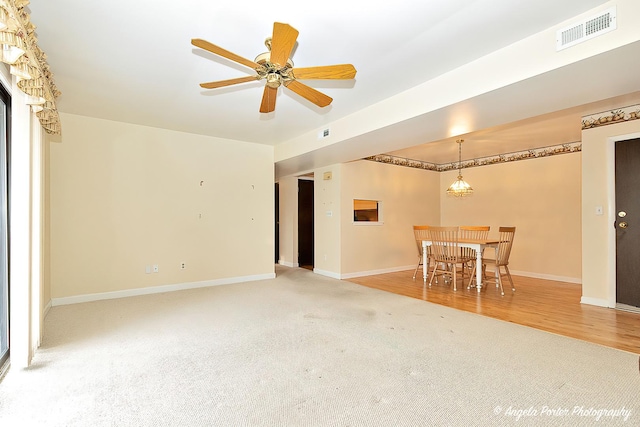 carpeted living room featuring ceiling fan