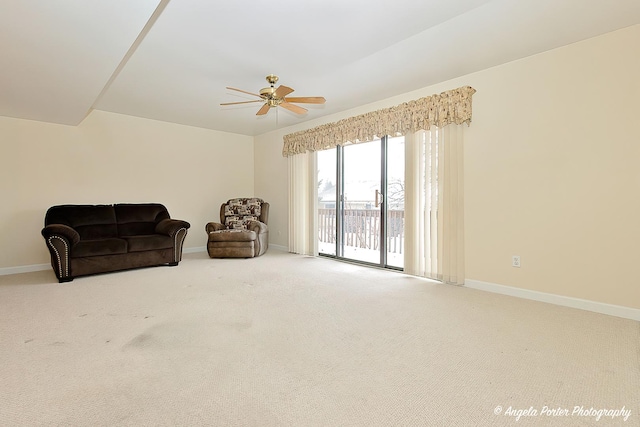 living area featuring ceiling fan and carpet flooring