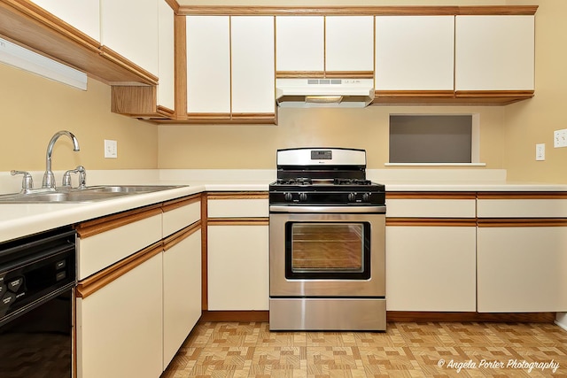 kitchen featuring sink, white cabinets, black dishwasher, and stainless steel gas stove