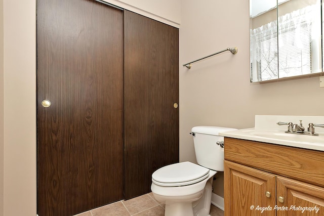 bathroom featuring vanity, toilet, and tile patterned flooring