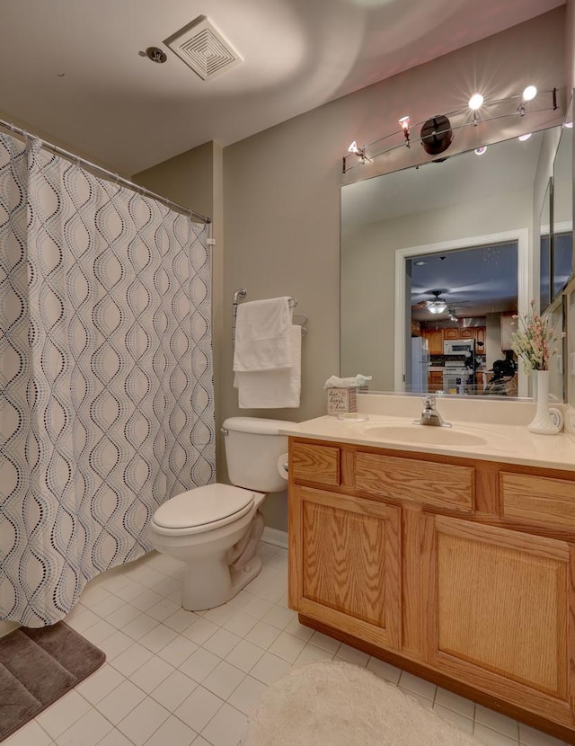 bathroom featuring toilet, tile patterned floors, and vanity