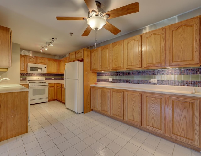 kitchen featuring white appliances, decorative backsplash, track lighting, ceiling fan, and light tile patterned flooring