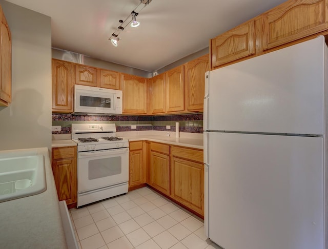 kitchen with sink, white appliances, decorative backsplash, and light tile patterned floors