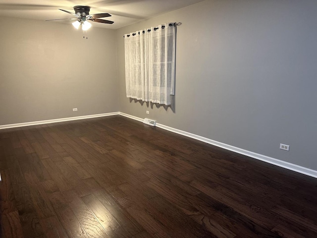 spare room featuring ceiling fan and dark hardwood / wood-style flooring