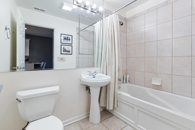 bathroom featuring toilet, tile patterned flooring, and shower / bath combo with shower curtain