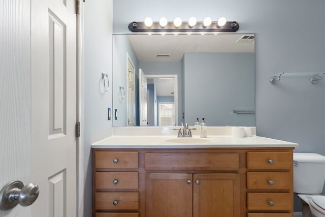 bathroom featuring vanity and toilet