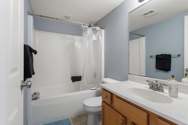 full bathroom featuring shower / bath combination with curtain, tile patterned flooring, vanity, toilet, and a textured ceiling