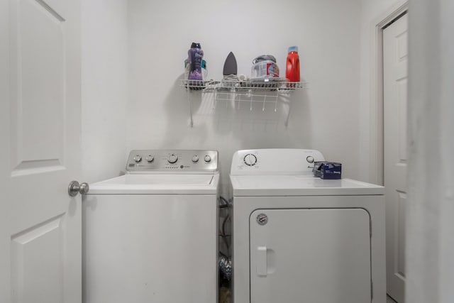 clothes washing area featuring separate washer and dryer