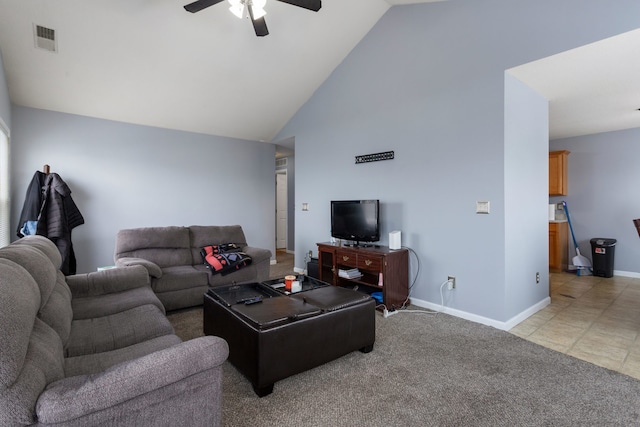 carpeted living room with ceiling fan and vaulted ceiling