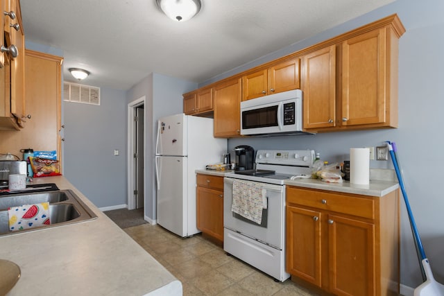 kitchen with sink and white appliances