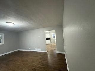 spare room with dark hardwood / wood-style flooring