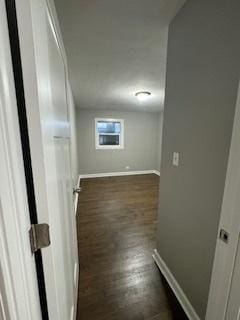 corridor with dark hardwood / wood-style flooring