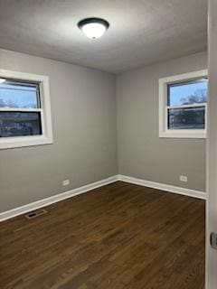 unfurnished room featuring dark hardwood / wood-style floors