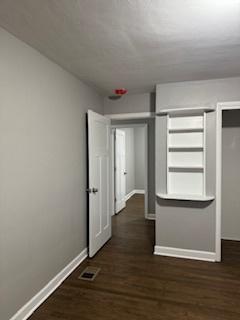 hallway featuring dark wood-type flooring