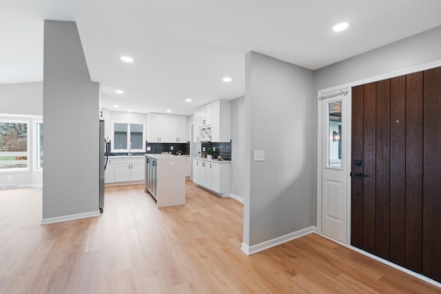 foyer featuring sink and light hardwood / wood-style flooring