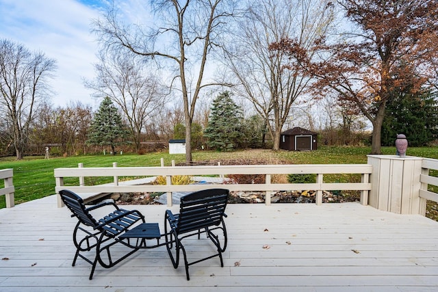 wooden deck featuring a lawn and a storage unit