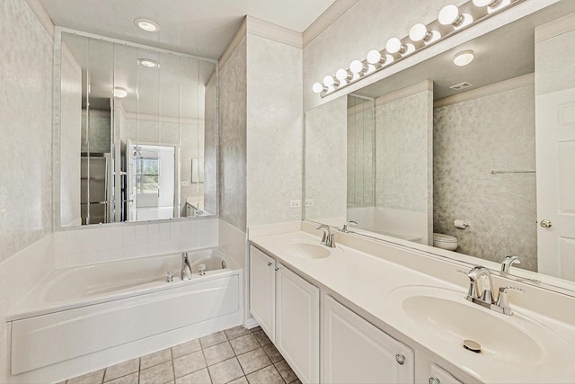 bathroom with tile patterned flooring, vanity, a bath, and toilet