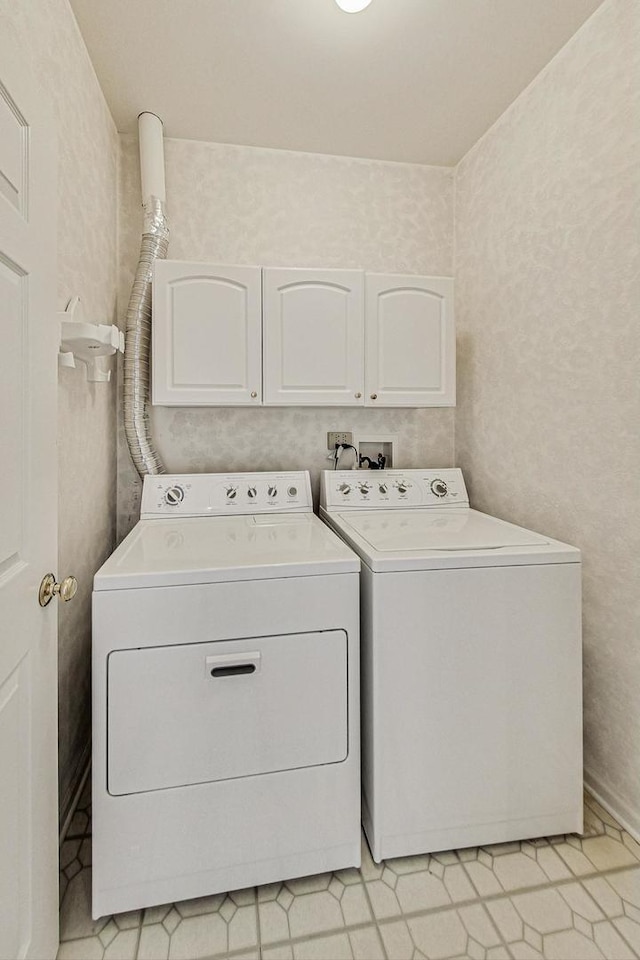 washroom featuring separate washer and dryer and cabinets