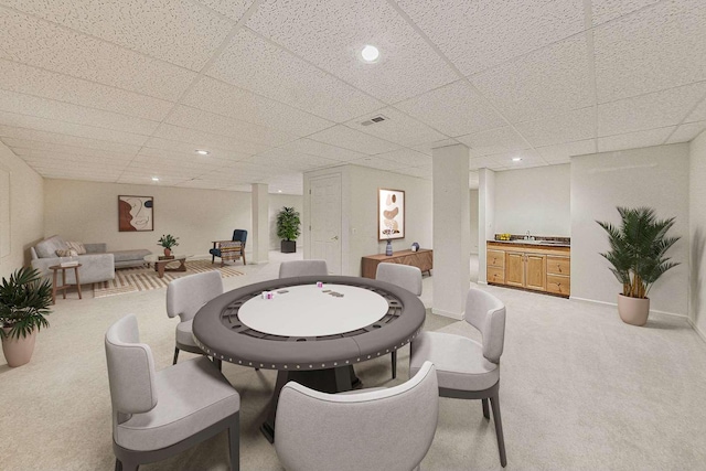 game room featuring sink, light carpet, and a drop ceiling