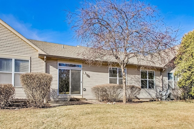 rear view of property with a lawn