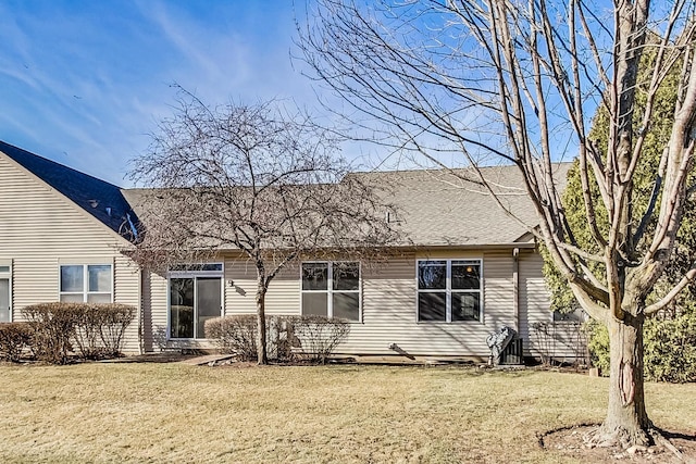 rear view of property featuring a yard