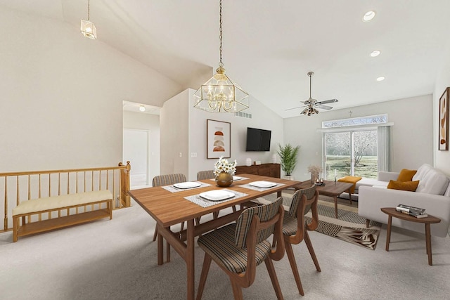 carpeted dining area with high vaulted ceiling