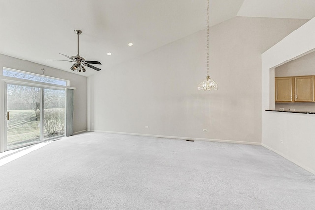 spare room with high vaulted ceiling, ceiling fan with notable chandelier, and light carpet