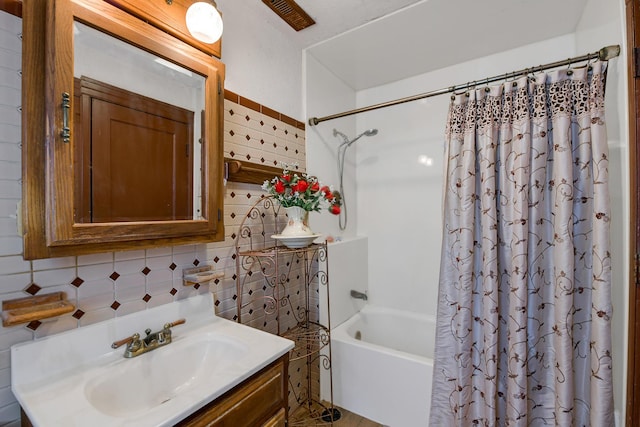 bathroom with vanity, backsplash, and shower / tub combo