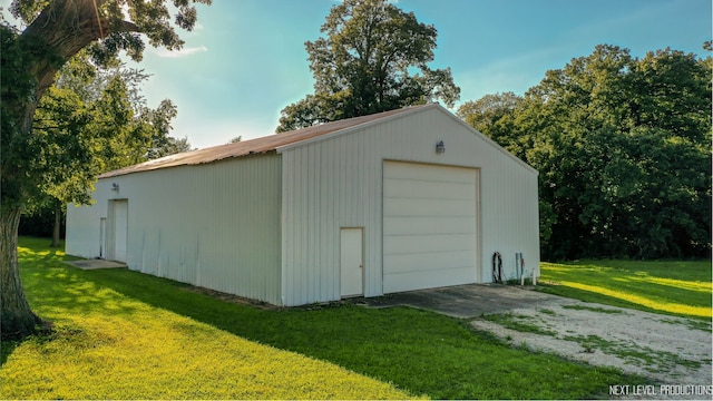 view of outbuilding featuring a lawn and a garage