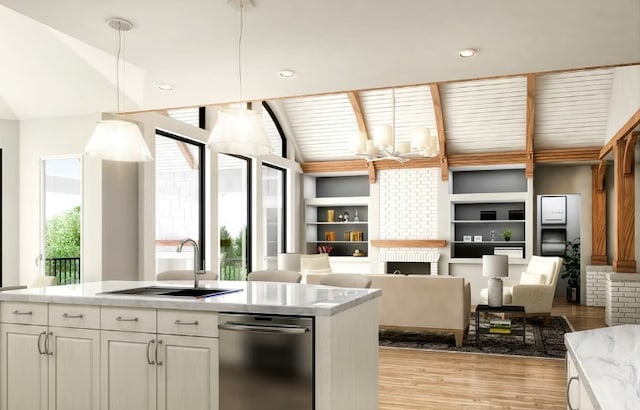 kitchen with white cabinets, dishwasher, lofted ceiling, a fireplace, and hanging light fixtures