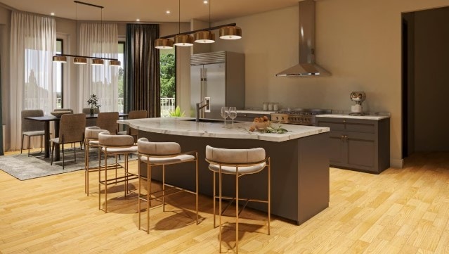 kitchen featuring light hardwood / wood-style flooring, stainless steel built in fridge, gray cabinetry, range, and wall chimney range hood