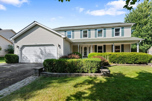 view of front facade with a front yard, a porch, and a garage