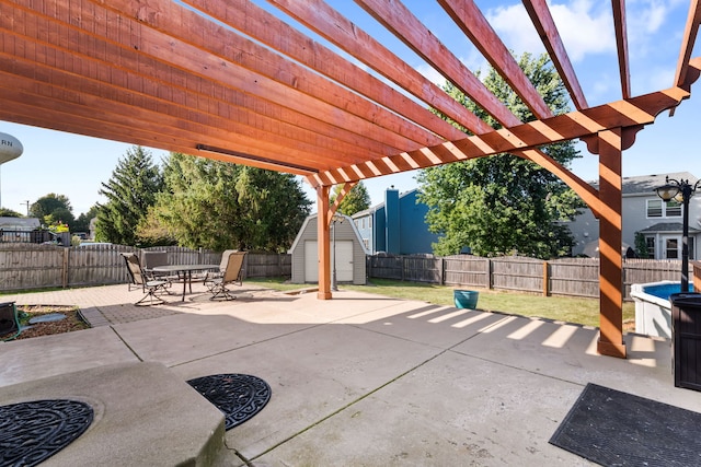 view of patio with a pergola and a shed