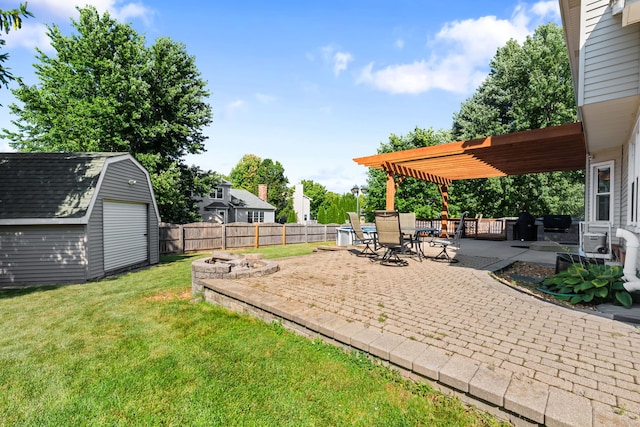 view of yard with a patio area, an outdoor fire pit, a pergola, and a shed