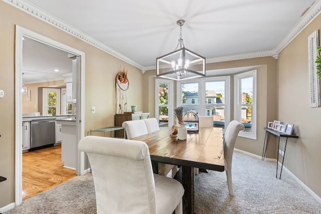 carpeted dining space with a notable chandelier and ornamental molding