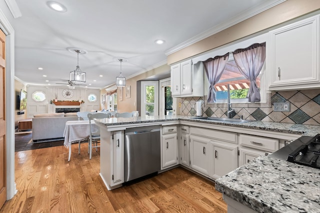 kitchen featuring pendant lighting, backsplash, white cabinetry, and dishwasher