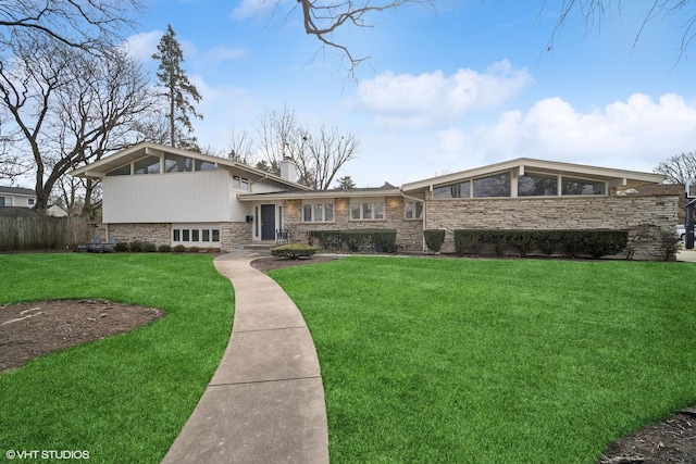 tri-level home featuring a sunroom and a front lawn